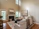 Bright living room with high ceilings, fireplace, and hardwood floors at 207 Reedhaven Dr, Cary, NC 27513