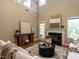 Open-concept living room with fireplace, hardwood floors, and plenty of natural light at 207 Reedhaven Dr, Cary, NC 27513