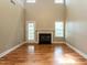 A living room features hardwood floors, a fireplace and natural lighting at 207 Reedhaven Dr, Cary, NC 27513
