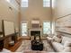 Inviting living room with fireplace, high ceilings, and hardwood floors at 207 Reedhaven Dr, Cary, NC 27513