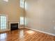 A living room features hardwood floors, a fireplace and natural lighting at 207 Reedhaven Dr, Cary, NC 27513