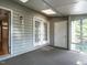 Inviting screened porch with skylights, gray siding, and views to the home's exterior at 207 Reedhaven Dr, Cary, NC 27513