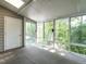 Light-filled screened porch offering views of lush greenery and a tranquil water feature at 207 Reedhaven Dr, Cary, NC 27513