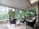 Bright sunroom with large windows offering scenic views and comfortable seating at 207 Reedhaven Dr, Cary, NC 27513