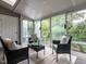 Bright sunroom with large windows offering scenic views and comfortable seating at 207 Reedhaven Dr, Cary, NC 27513