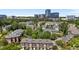 Beautiful aerial view of townhomes, mature trees, and the city skyline in the distance at 212 Allister Dr, Raleigh, NC 27609
