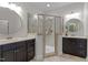 Well-appointed bathroom showcasing double vanities, a glass shower enclosure, and neutral tiling at 212 Allister Dr, Raleigh, NC 27609