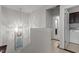 Hallway featuring tile flooring, a pendant light, and views of laundry room and another room at 212 Allister Dr, Raleigh, NC 27609