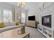 Comfortable living room featuring a fireplace, stylish furniture, and an entertainment center at 212 Allister Dr, Raleigh, NC 27609