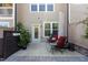 Cozy outdoor patio with comfortable seating, lush greenery, and a privacy fence at 212 Allister Dr, Raleigh, NC 27609