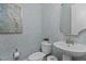 Charming powder room with patterned wallpaper, modern fixtures, and a well-lit space at 212 Allister Dr, Raleigh, NC 27609
