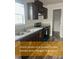 Well-equipped kitchen with stainless steel appliances, dark cabinetry, and a view of an adjacent storage area at 212 Ellington Path, Henderson, NC 27537