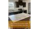 Modern kitchen featuring stainless steel appliances, granite countertops, and dark wood cabinetry at 212 Ellington Path, Henderson, NC 27537