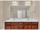 Bathroom features double vanity with a framed mirror, white countertops, and wood cabinets at 215 Oxfordshire Dr, Fuquay Varina, NC 27526