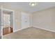 Bedroom has carpet, double closets, neutral paint, and a doorway view of another room at 215 Oxfordshire Dr, Fuquay Varina, NC 27526