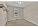 Cozy carpeted bedroom features neutral paint, a window with blinds, and a convenient overhead light fixture at 215 Oxfordshire Dr, Fuquay Varina, NC 27526