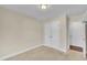 Bedroom with carpet, double closets, neutral paint, and a doorway view of another room at 215 Oxfordshire Dr, Fuquay Varina, NC 27526