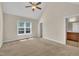 Spacious bedroom with vaulted ceilings, ceiling fan, and ample natural light from the window at 215 Oxfordshire Dr, Fuquay Varina, NC 27526