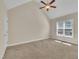Bedroom features vaulted ceiling, fan, and natural light from a window overlooking the exterior at 215 Oxfordshire Dr, Fuquay Varina, NC 27526