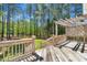 Relaxing deck with pergola overlooks wooded backyard and features wood railings and stairs at 215 Oxfordshire Dr, Fuquay Varina, NC 27526