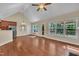 Bright dining area featuring hardwood floors, a vaulted ceiling, and large windows offering natural light at 215 Oxfordshire Dr, Fuquay Varina, NC 27526