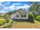 Side view of a charming single-story home with a well-manicured lawn and lush landscaping at 215 Oxfordshire Dr, Fuquay Varina, NC 27526