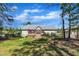Back exterior features a well-maintained yard, deck, and storage shed at 215 Oxfordshire Dr, Fuquay Varina, NC 27526