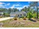 Attractive single-story home with colorful, low-maintenance landscaping with attached garage and lush greenery at 215 Oxfordshire Dr, Fuquay Varina, NC 27526