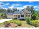 Beautiful single-story home with attached garage, manicured lawn, and beautiful, colorful landscaping at 215 Oxfordshire Dr, Fuquay Varina, NC 27526