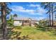 Back exterior features a well-maintained yard, deck, and storage shed at 215 Oxfordshire Dr, Fuquay Varina, NC 27526