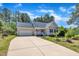 Inviting single-story home with attached garage, long driveway and a well-manicured lawn and landscaping at 215 Oxfordshire Dr, Fuquay Varina, NC 27526