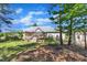 Back exterior features a well-maintained yard, deck, and storage shed at 215 Oxfordshire Dr, Fuquay Varina, NC 27526