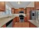 Modern kitchen featuring stainless steel appliances, ample cabinetry, and granite countertops at 215 Oxfordshire Dr, Fuquay Varina, NC 27526