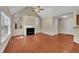 Open living room with hardwood floors, fireplace, and seamless access to the kitchen and dining area at 215 Oxfordshire Dr, Fuquay Varina, NC 27526