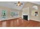 Spacious living room with hardwood floors, fireplace, vaulted ceilings, and natural light at 215 Oxfordshire Dr, Fuquay Varina, NC 27526