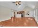 Open-concept living room with hardwood floors, fireplace, and a view into the modern kitchen and dining area at 215 Oxfordshire Dr, Fuquay Varina, NC 27526