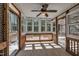 Inviting sunroom with natural light features white shiplap, wood trim, and a ceiling fan at 215 Oxfordshire Dr, Fuquay Varina, NC 27526