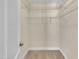 Walk-in closet with metal storage shelves, neutral paint and base trim at 215 Oxfordshire Dr, Fuquay Varina, NC 27526