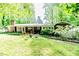 View of the home's backyard featuring mature trees and outdoor seating at 2307 Piedmont Dr, Sanford, NC 27330