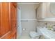 Compact bathroom with a toilet, sink, cabinet storage, and a simple shower at 2307 Piedmont Dr, Sanford, NC 27330