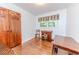 A quaint bedroom with hardwood floors, a pair of wooden chairs, and a storage closet at 2307 Piedmont Dr, Sanford, NC 27330