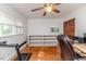 Neutral tone bedroom featuring hardwood floors, a ceiling fan, and a bookshelf at 2307 Piedmont Dr, Sanford, NC 27330