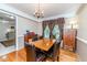 Elegant dining room featuring hardwood floors, a wooden table, and large windows at 2307 Piedmont Dr, Sanford, NC 27330