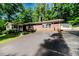 Traditional brick home with a well-manicured lawn, a detached garage and paved driveway at 2307 Piedmont Dr, Sanford, NC 27330