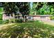 Charming brick home with a well-maintained front yard, lush landscaping and inviting porch at 2307 Piedmont Dr, Sanford, NC 27330