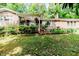 Beautiful brick home featuring an inviting covered porch with decorative plants at 2307 Piedmont Dr, Sanford, NC 27330