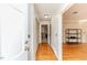 Bright hallway with hardwood floors, white trim, and access to multiple rooms at 2307 Piedmont Dr, Sanford, NC 27330