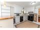 Classic kitchen with white cabinets, open shelving, and sleek black appliances at 2307 Piedmont Dr, Sanford, NC 27330
