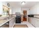 Traditional kitchen features white cabinets, stone countertops, and modern appliances at 2307 Piedmont Dr, Sanford, NC 27330