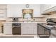 Bright kitchen with white cabinets, modern appliances, and a window view at 2307 Piedmont Dr, Sanford, NC 27330